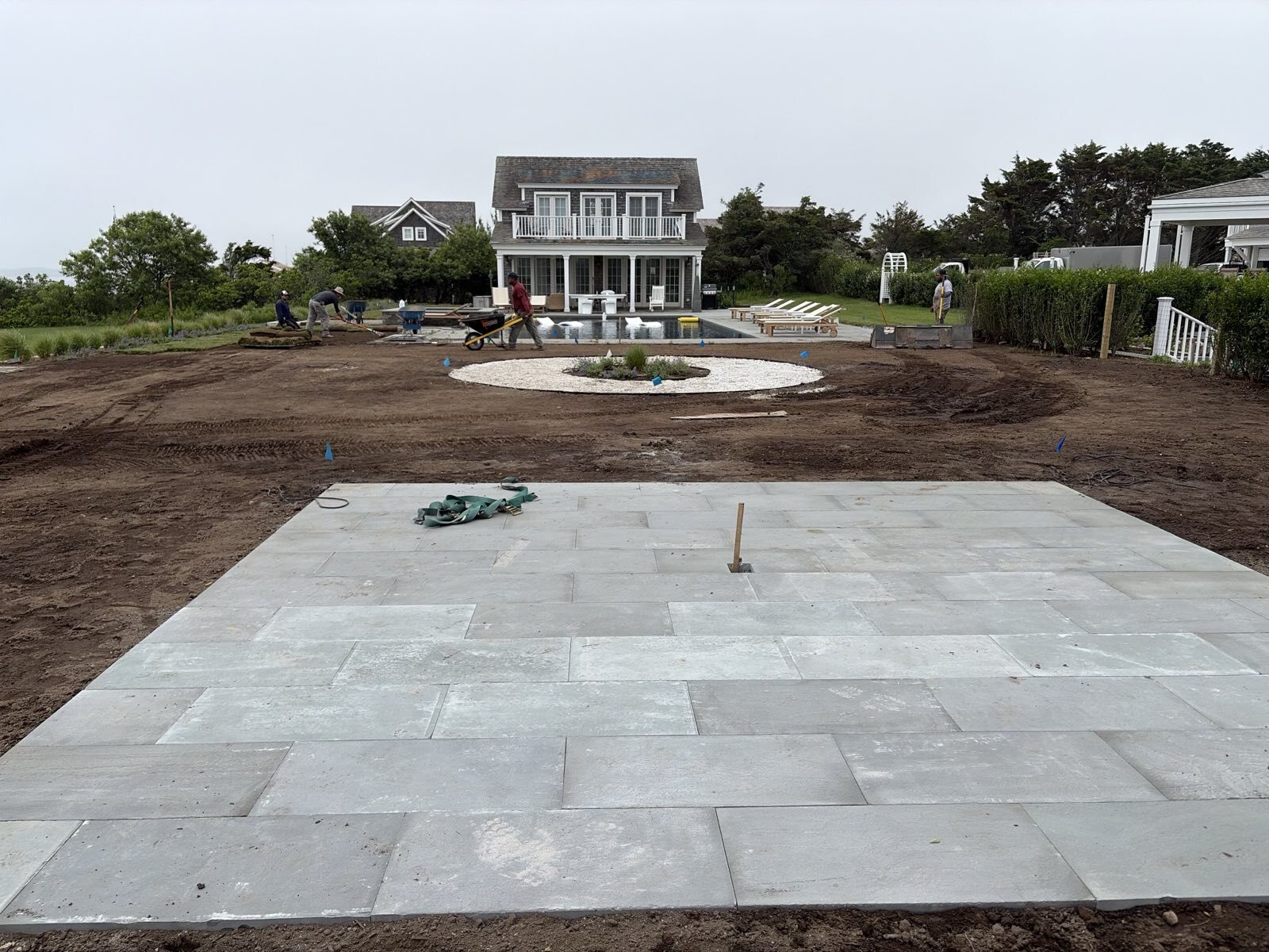 Ryan Conway Landscaping crew installing a bluestone patio, lawn and plantings at a Nantucket coastal estate